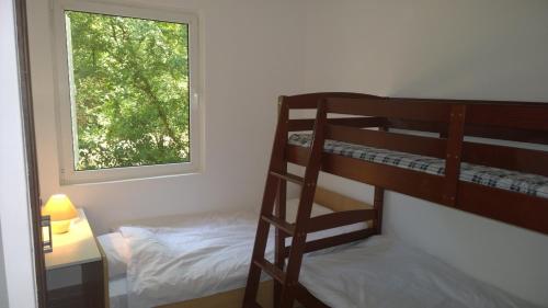 a bedroom with two bunk beds and a window at Holiday Home Momcilovic in Malinska