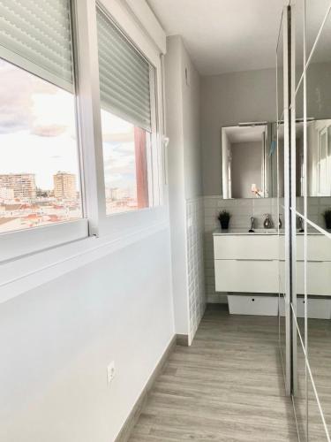 a bathroom with a sink and a window at Luxury Attics Avenida Italia PARKING INCLUIDO in Huelva