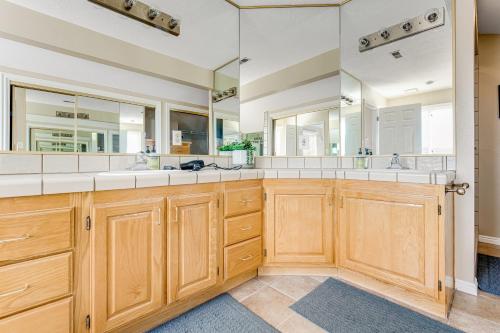 a bathroom with two sinks and a large mirror at Penthouse at the Village in St. George