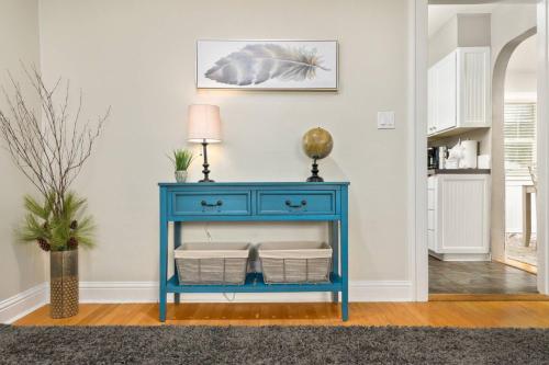 a blue console table with baskets in a living room at Edwards Retreat in Newberg