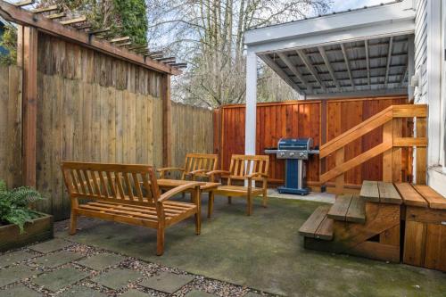a patio with four chairs and a grill and a table at Edwards Retreat in Newberg