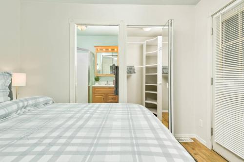 a white bedroom with a bed and a closet at Edwards Retreat in Newberg