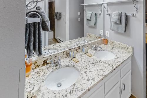 a bathroom with two sinks and a large mirror at Beaver Village 15-11 in Winter Park