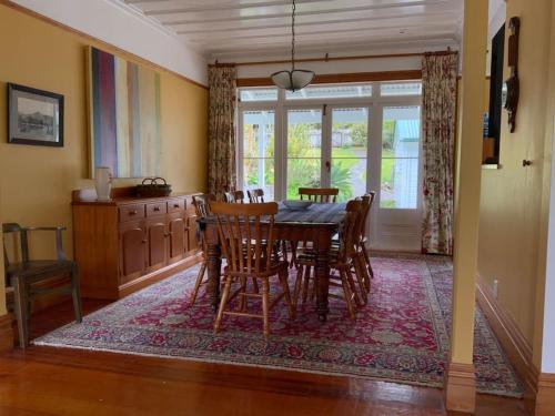 a dining room with a table and chairs at Glenfern Sanctuary in Port Fitzroy