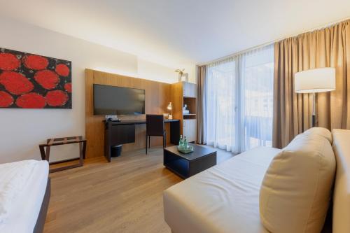 a hotel room with a bed and a flat screen tv at m3Hotel in Sankt Anton am Arlberg