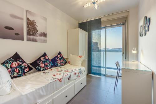 a bedroom with a bed and a large window at El Medano, La Tejita in El Médano