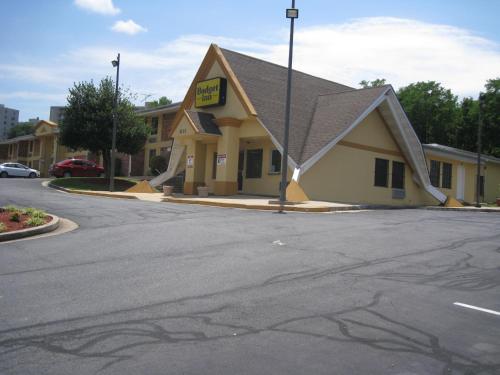 a building with a sign on the side of a street at Budget Inn Temple Hills in Temple Hills