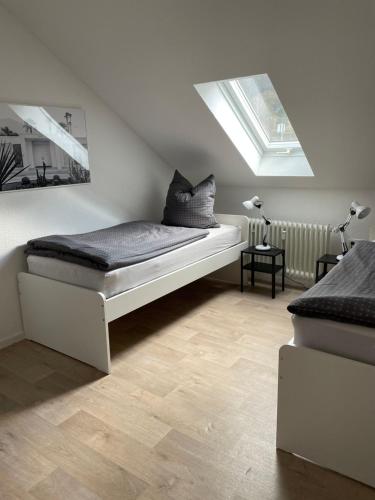 a bedroom with two beds and a skylight at Ferienwohnung Mica in Bad Kissingen