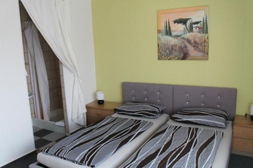 a bedroom with a bed and a picture on the wall at Gasthaus Zur Sonne in Freiburg im Breisgau