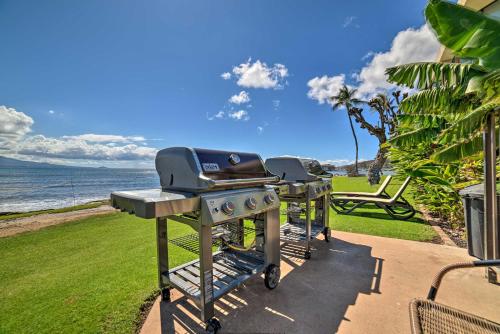 two bbq grill on a patio next to the ocean at Luxurious Maui Getaway with Panoramic Ocean Views! in Wailuku