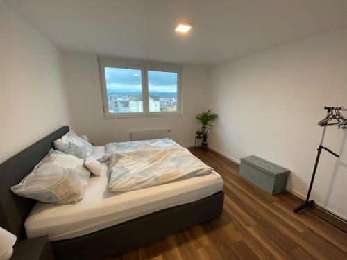 a bedroom with a bed and a window in a room at Apartment Seeblick in Arbon von Swisspartments in Arbon