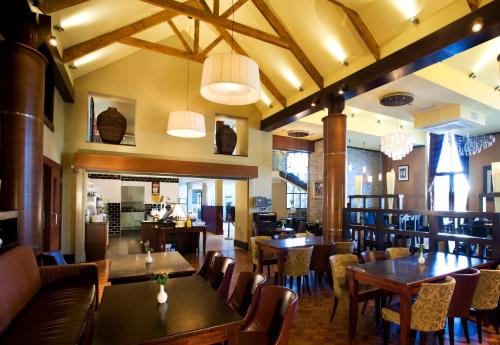a dining room with wooden tables and chairs at The Farmers Kitchen Hotel in Wexford