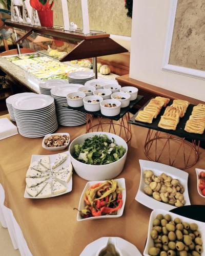 a table topped with bowls and plates of food at Hotel Liptakówka in Białka Tatrzanska