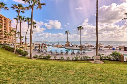 a resort with a pool and a beach with palm trees at Rocky Point Sonoran Resorts in Puerto Peñasco