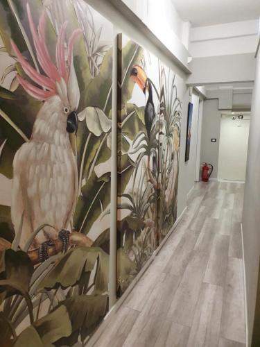 a hallway with a wall mural of a white bird at DOMUS FIESCHI Rooms self check in in Genova