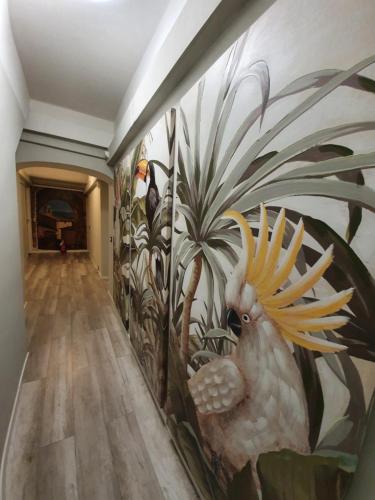 a hallway with a wall with a mural of plants at DOMUS FIESCHI Rooms self check in in Genova