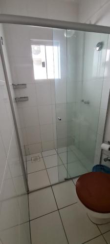 a bathroom with a glass shower with a toilet at Lacqua diRoma 1 - Apartamentos JN in Caldas Novas