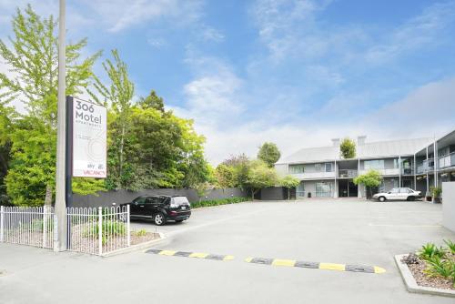 a parking lot with a sign in front of a building at 306 Motel Apartments in Christchurch