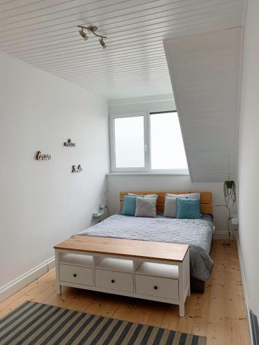 a bedroom with a bed with blue pillows at Tihany Panorama House in Tihany
