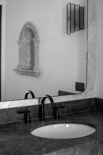 a bathroom with a sink and a mirror at Casa 1810 Parque Hotel Boutique in San Miguel de Allende