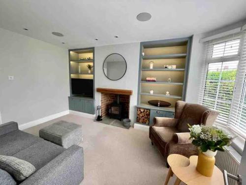 a living room with a couch and a fireplace at Modern Cottage Style House with Log Burner in Harrogate