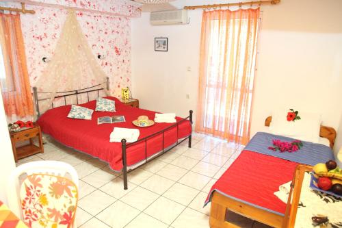 a bedroom with two beds and a christmas tree at Homer Studio in Nydri