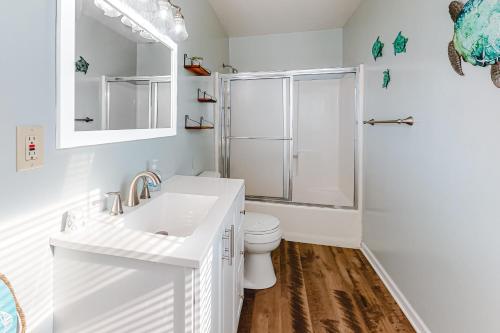 a white bathroom with a toilet and a shower at Marlin Cove II 1A in Ocean City