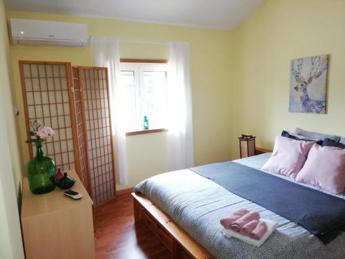 a bedroom with a bed with two towels on it at Casa Da Calçada in Castelo de Paiva