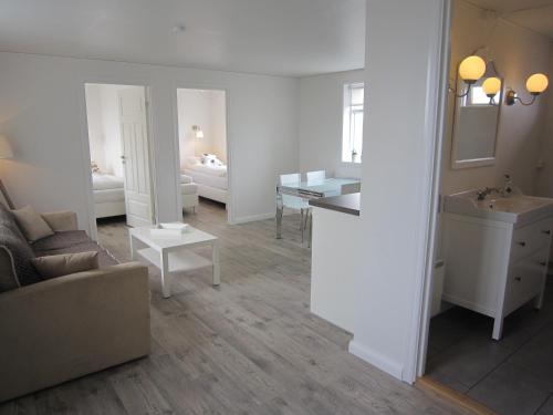 a living room with a sink and a bathroom at Apartment by the Sea in H&ouml;fn