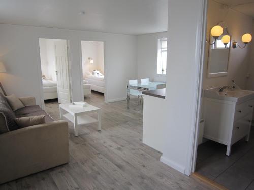 a living room with a sink and a bathroom at Apartment by the Sea in Höfn