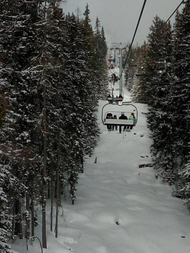 a group of people riding a ski lift in the snow at Ubytovanie u Jozefa / Strba in Štrba