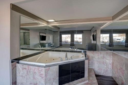 a large bathroom with a large bath tub at Motel 6 Burlington in Burlington