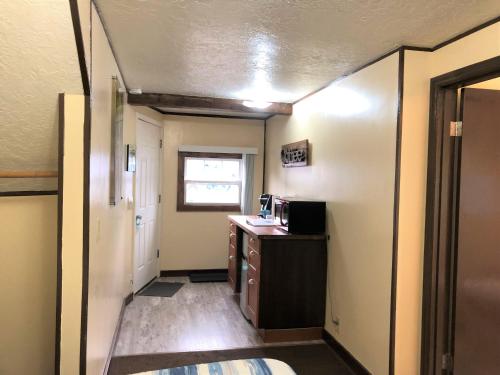 a hallway of a room with a kitchen with a desk at The Anchorage Motel in Pacific City