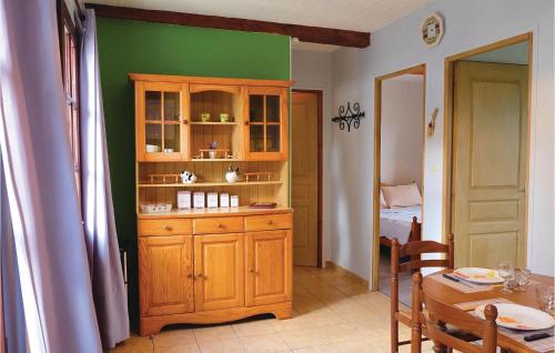 a kitchen with a wooden cabinet and a table at Beautiful Home In Hames-Boucres in Hames-Boucres