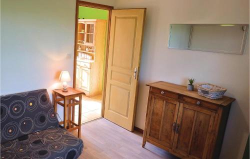 a living room with a chair and a door at Beautiful Home In Hames-Boucres in Hames-Boucres