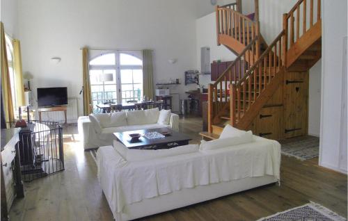 a living room with white furniture and a staircase at 5 Bedroom Nice Home In Azillanet in Azillanet