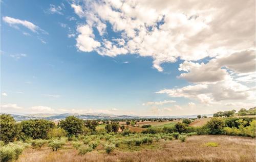 a view of a field with trees and clouds at Seranna 2 in Papiano