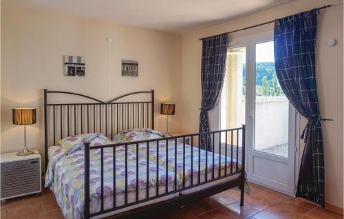a bedroom with a bed and a large window at Beautiful Home In Prades Sur Vernazobre With Outdoor Swimming Pool in Prades-sur-Vernazobre