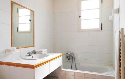 a bathroom with a sink and a tub and a mirror at Le Domaine De Fayence in Fayence