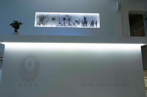a white exhibit with a picture on top of it at Hotel Casino Ridola in Matera