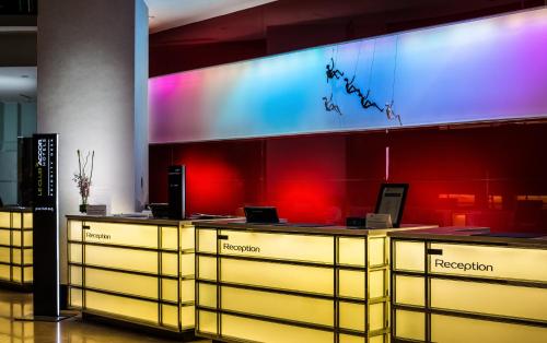 a lobby with yellow drawers and a red wall at Wyndham Grand Bangsar Kuala Lumpur in Kuala Lumpur