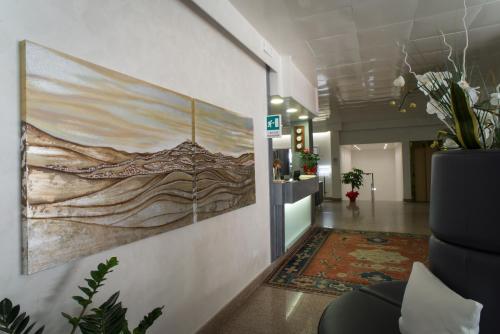 a hallway with a painting on the wall at Hotel Astoria in Fermo