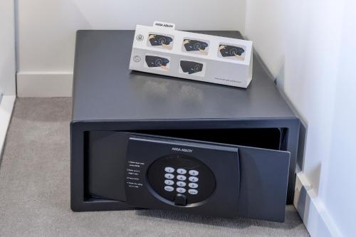 a microwave oven with a box on top of it at Brady Apartment Hotel Hardware Lane in Melbourne