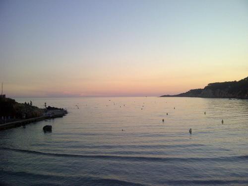 a large body of water with a group of people in it at O Petit Monde in Sanary-sur-Mer