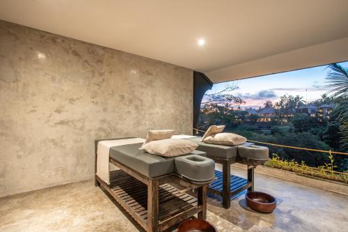 a bedroom with a bed and a large window at The Hidden Paradise Ubud - CHSE Certified in Ubud
