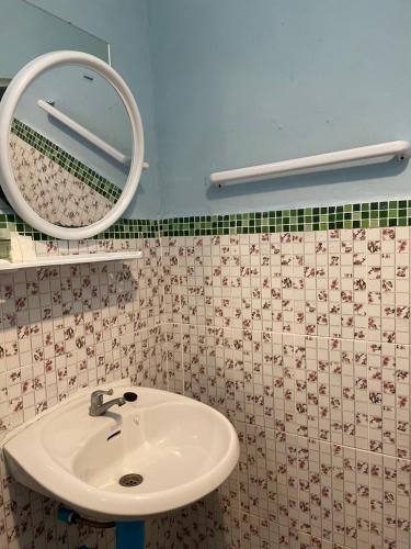 a bathroom with a sink and a mirror at Pai Modern House in Pai