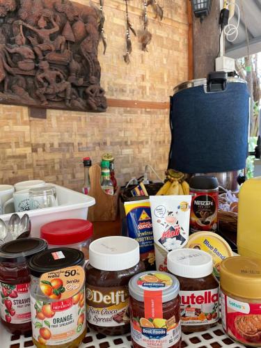 a counter topped with lots of different types of food at Pai Modern House in Pai