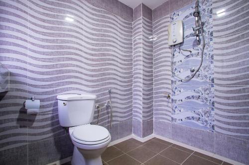 a bathroom with a toilet and a shower at MK Inn Hotel in Kuala Lumpur