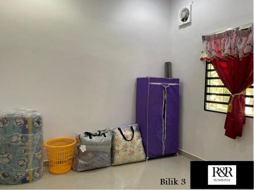 a room with bags on the floor and a window at R & R HOMESTAY in Tanjung Karang