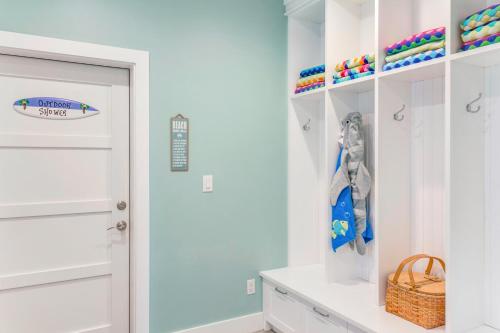 a white bathroom with a closet with white cabinets at Big Blue at Palmilla Beach in Port Aransas